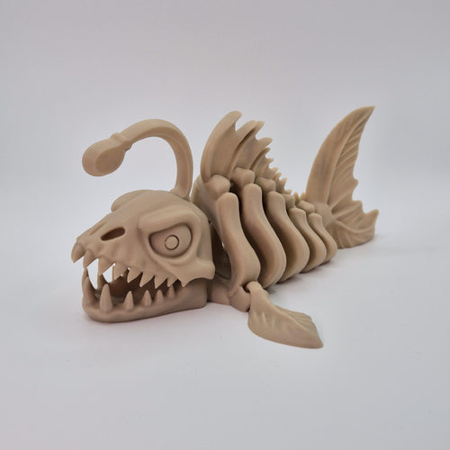 Angled front view of a bone-coloured 3D-printed articulating skeleton Anglerfish toy