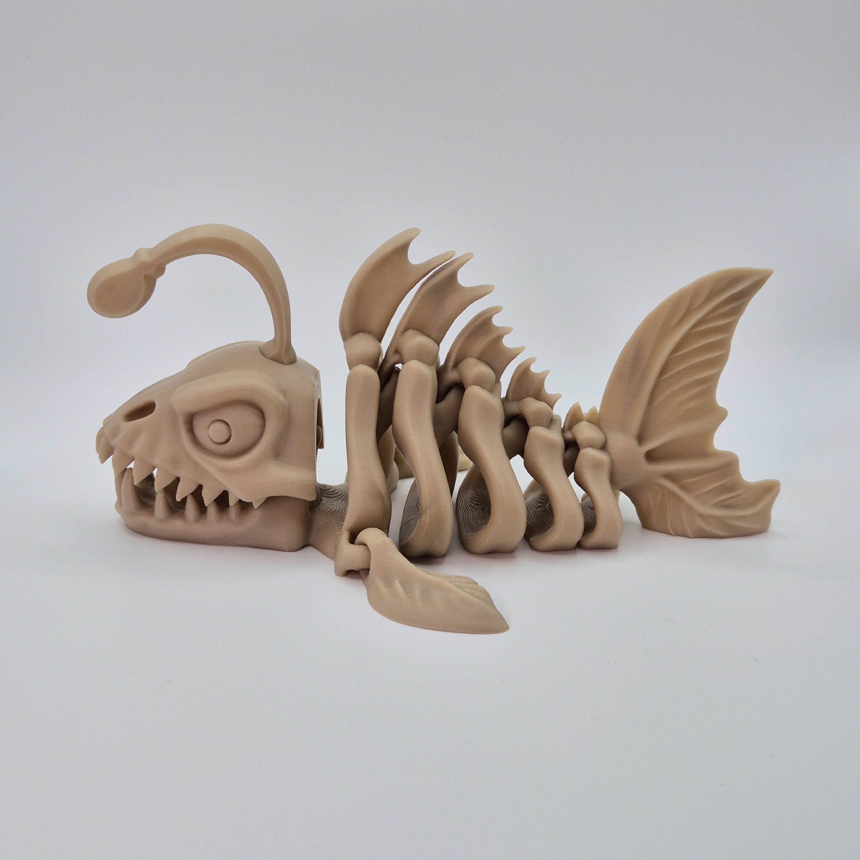 Side view of a bone-coloured 3D-printed articulating skeleton Anglerfish toy