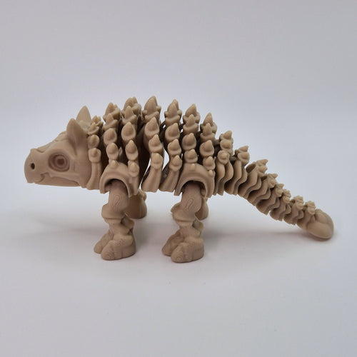   Side view of a bone-coloured 3D-printed articulating skeleton Ankylosaurus toy
