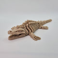 Angled front view of a bone-coloured 3D-printed articulating skeleton Mosasaurus toy