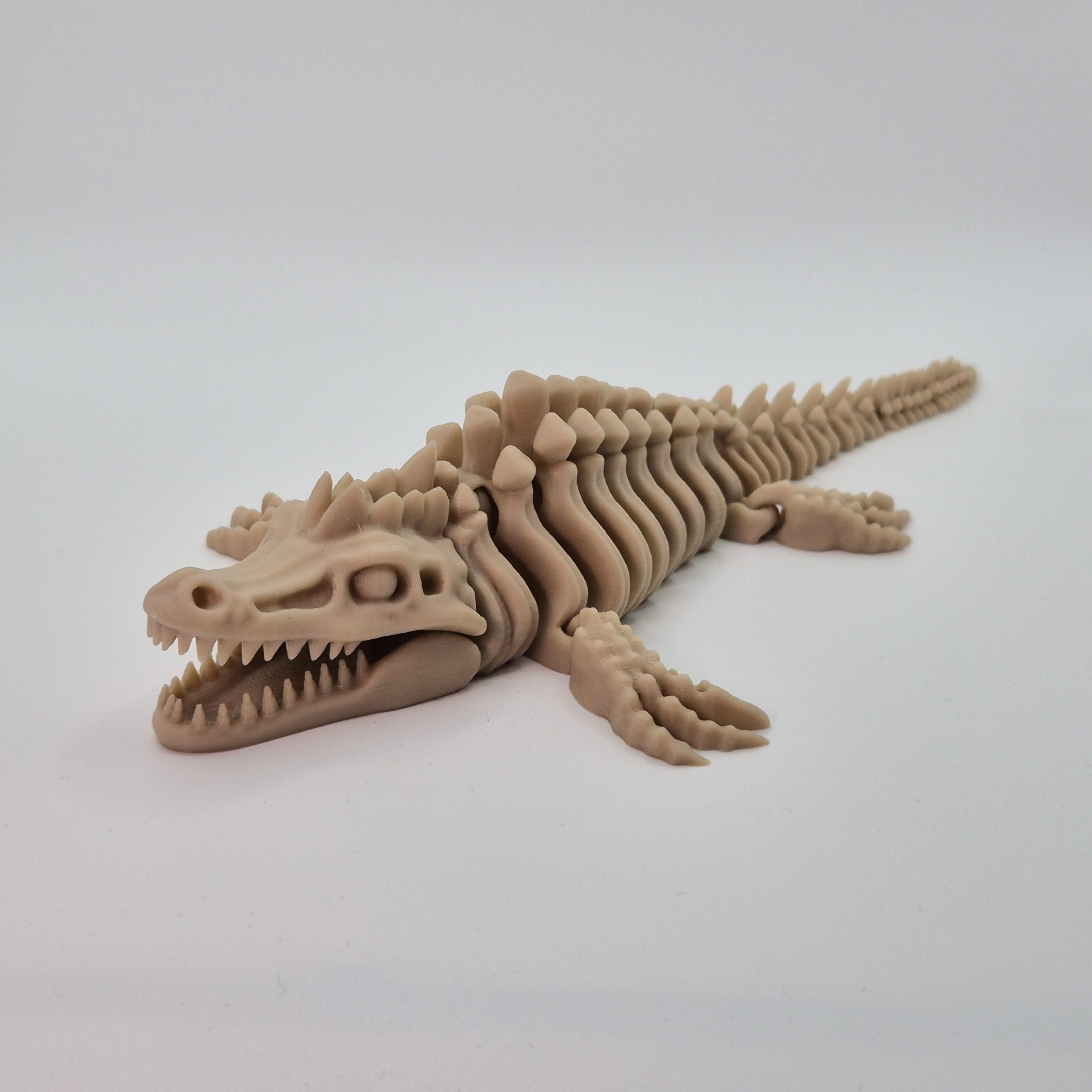 Angled front view of a bone-coloured 3D-printed articulating skeleton Mosasaurus toy