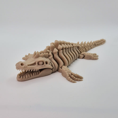 Angled front view of a bone-coloured 3D-printed articulating skeleton Mosasaurus toy