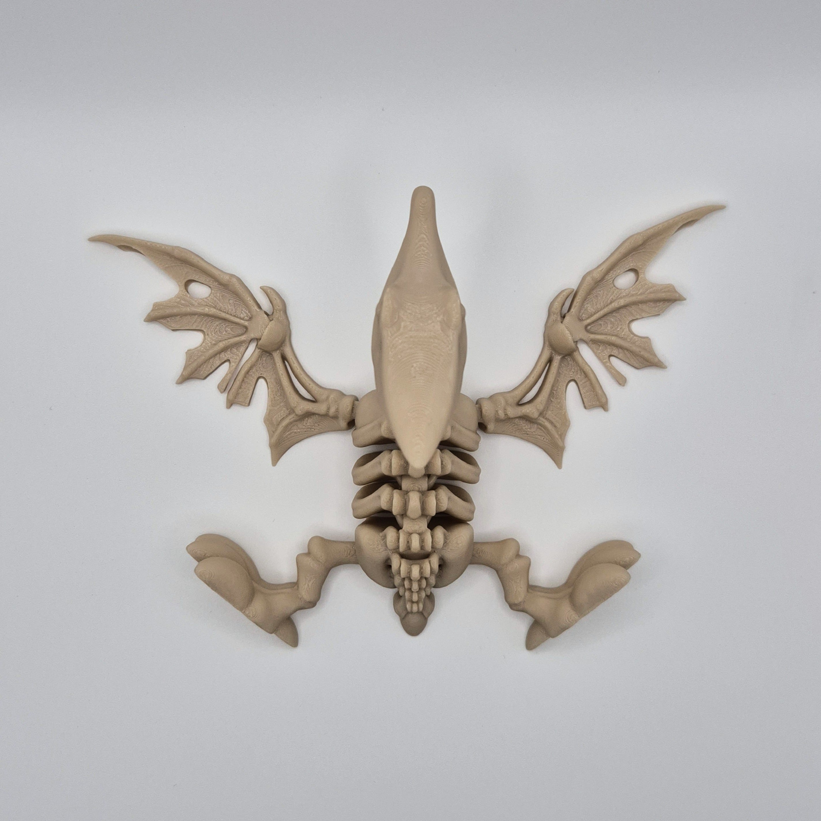 Top view of a bone-coloured 3D-printed articulating skeleton Pteranodon toy