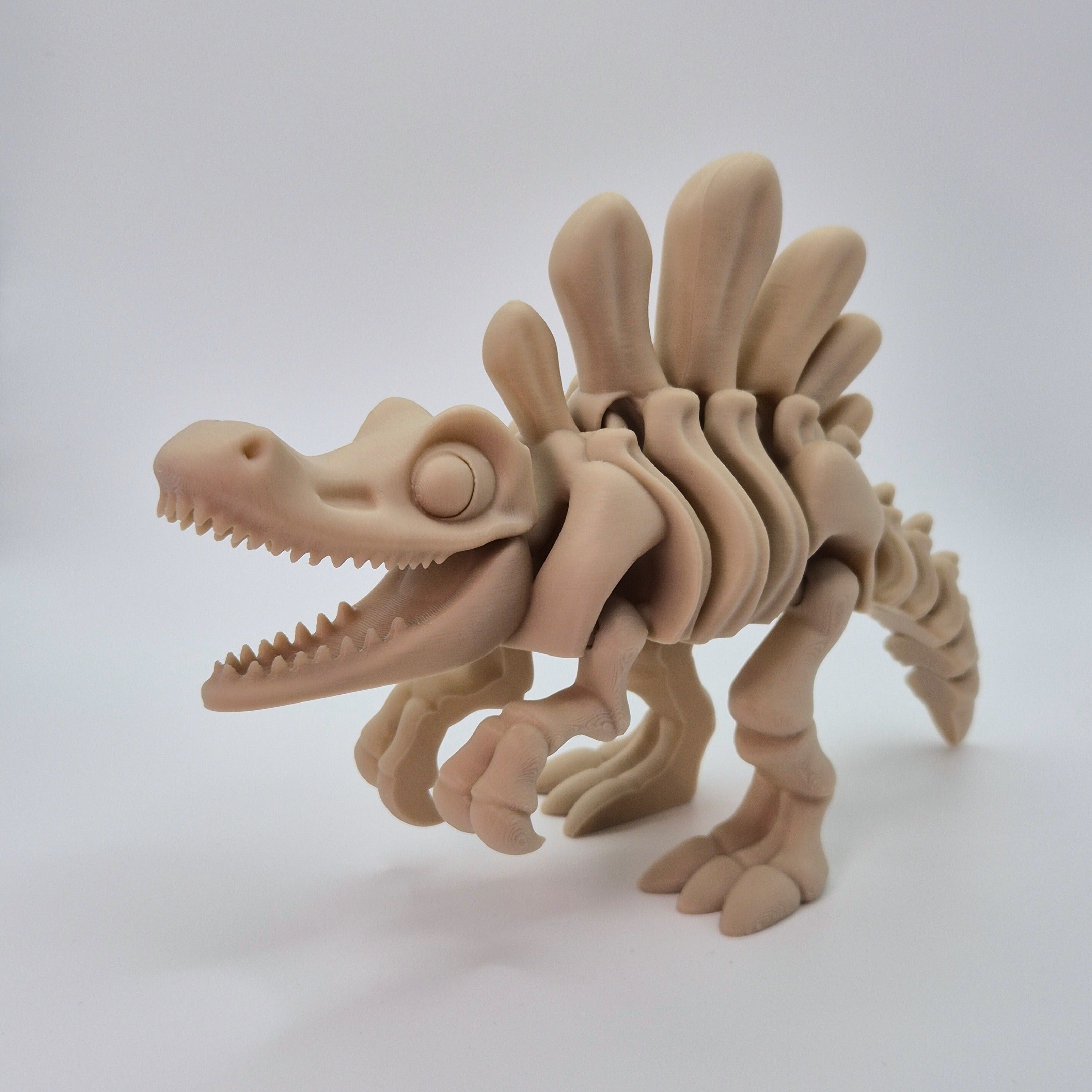 Angled front view of a bone-coloured 3D-printed articulating skeleton Spinosaurus toy