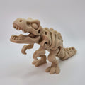 Angled front view of a bone-coloured 3D-printed articulating skeleton Tyrannosaurus Rex toy