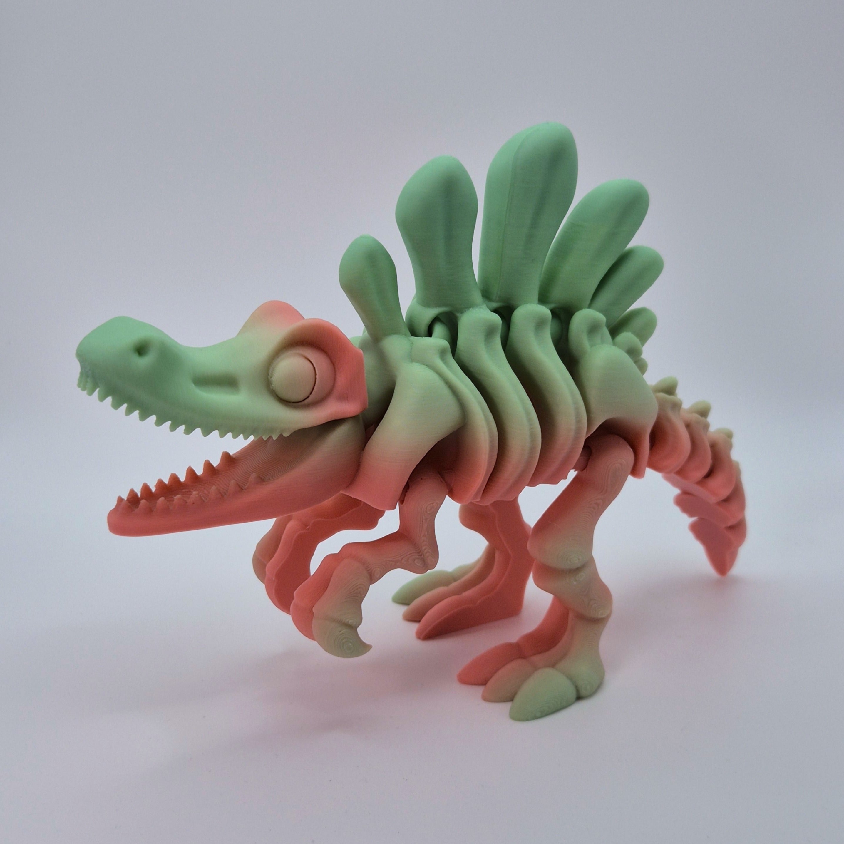 Angled front view of a sherbet-coloured 3D-printed articulating skeleton Spinosaurus toy